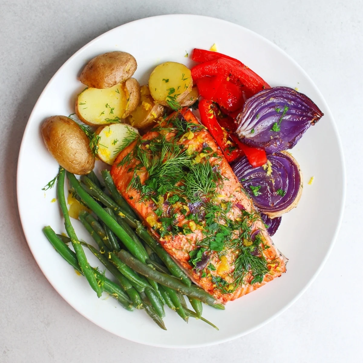 Golden-brown Lemon Herb Salmon & Potato sheet pan, ready to serve with fresh lemon wedges.