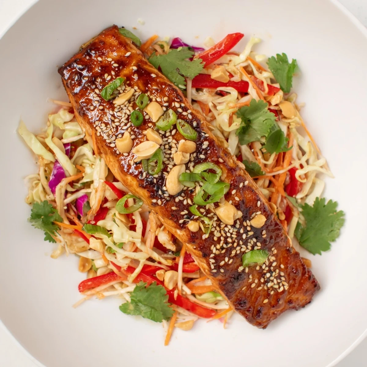 Tender teriyaki salmon contrasted by a crisp Asian slaw, a beautiful and healthy bowl.