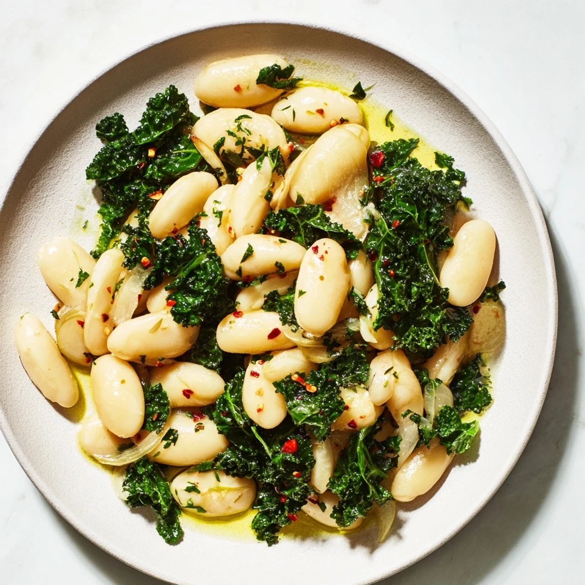 Steaming bowl of Garlicky Beans with Winter Greens, a vibrant, savory Mediterranean recipe ready to enjoy.