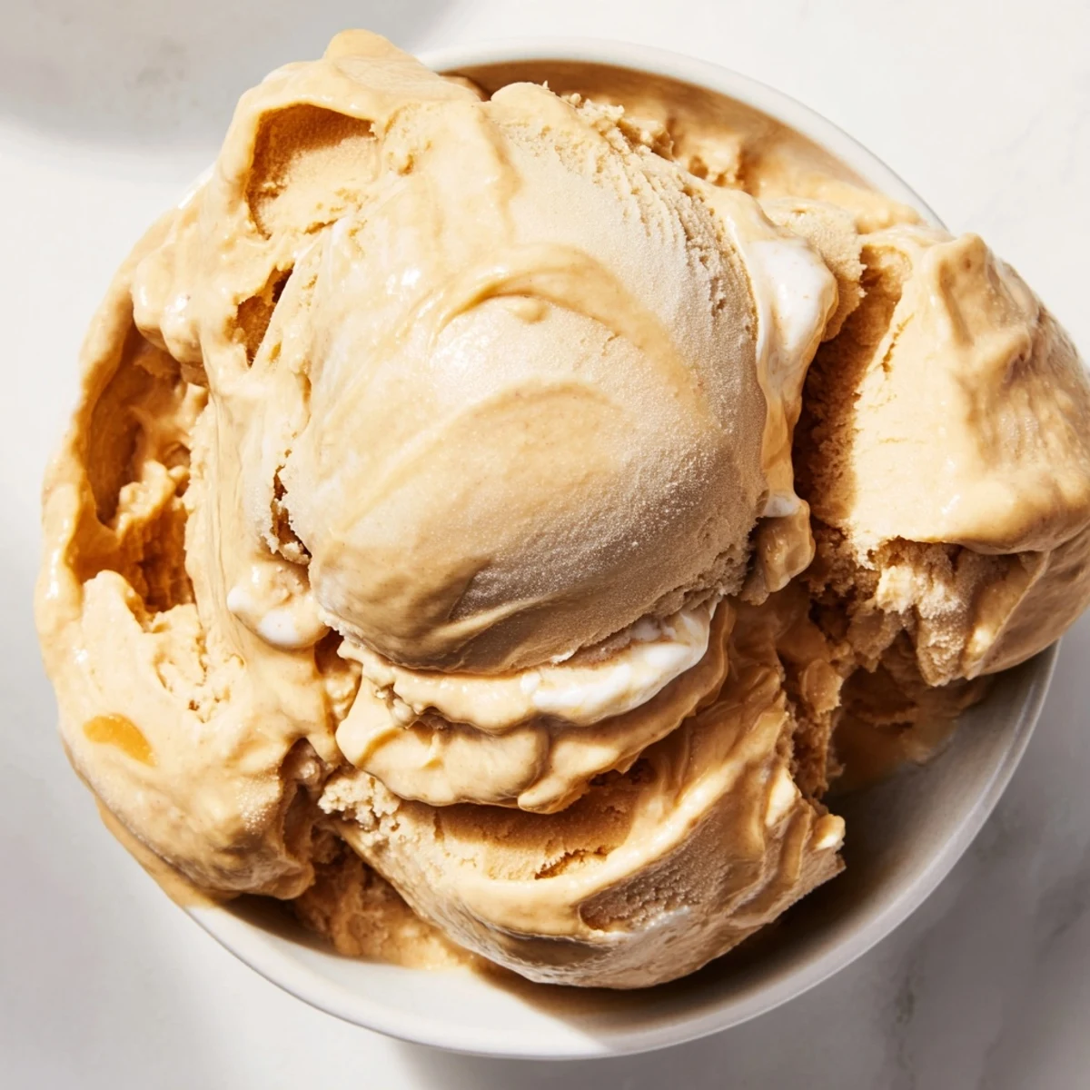 Creamy Peanut Butter Banana Ice Cream, swirled with peanut butter and ready to eat, a perfect vegan dessert.