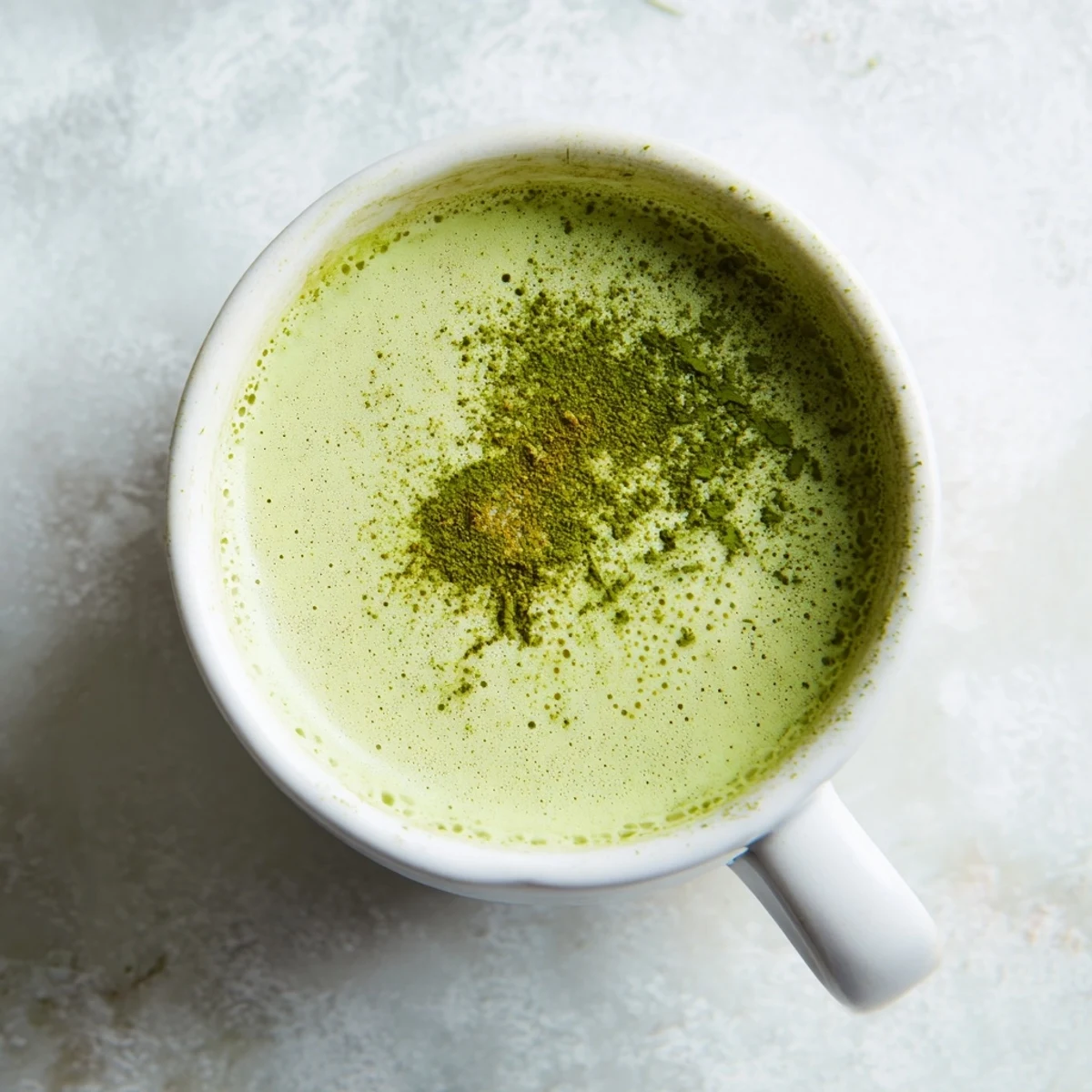 Imagine a vibrant green Coconut Ginger Matcha Winter Immunity Latte, swirling in a clear glass, ready to uplift.