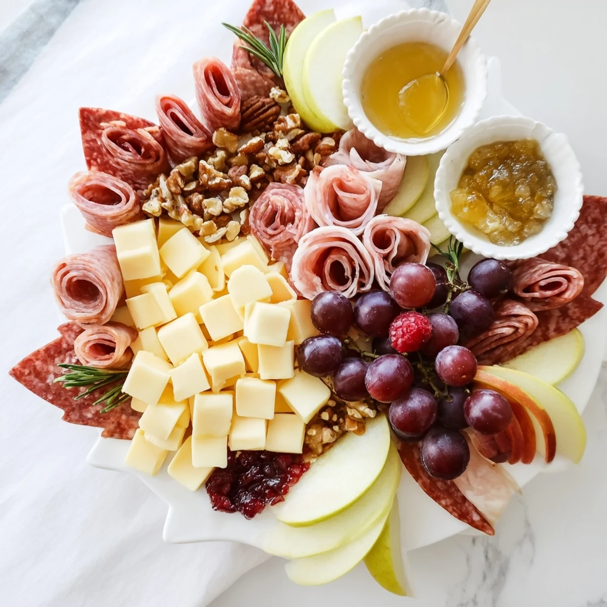 Festive maple leaf grazing tray, brimming with cheeses, meats, fruits, and crackers for autumn entertaining.