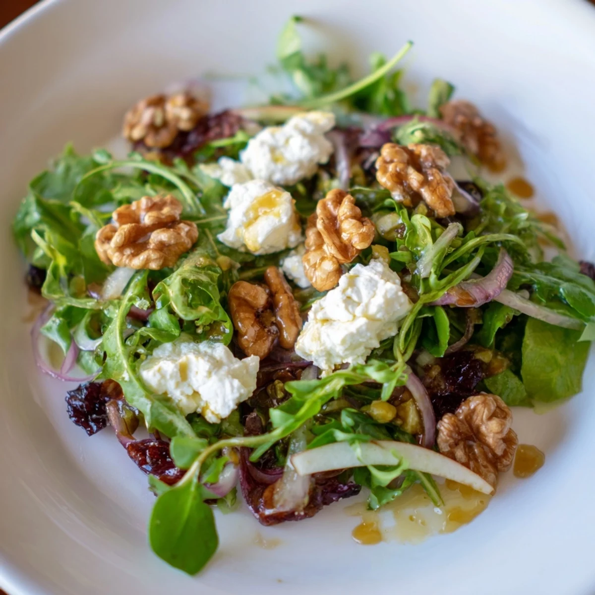 Spiced Honey and Date Goat Cheese Salad with creamy goat cheese and vibrant colors, ready to serve with warm dressing.