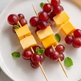 Delicious Cheese & Grape Skewers, a simple appetizer perfect for parties, with vibrant red grapes.
