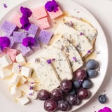 Pastel-colored fruit and creamy cheeses make up this stunning Lavender Haze Dreamscape cheese board.