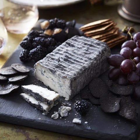 Elegant Monochrome Gray Stone Cheese Board, complete with ash-rinded cheeses, waiting to be served.