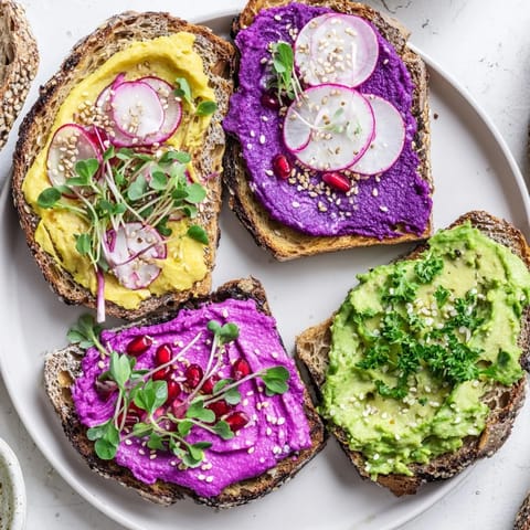 Colorful breakfast toasts featuring creamy ube and fresh avocado, perfect for brunch.  