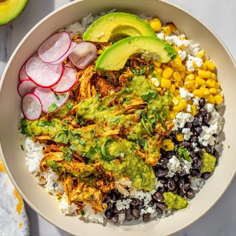 This Tex-Mex Green Enchiladas Rice Bowl features tender chicken smothered in flavorful enchilada sauce.