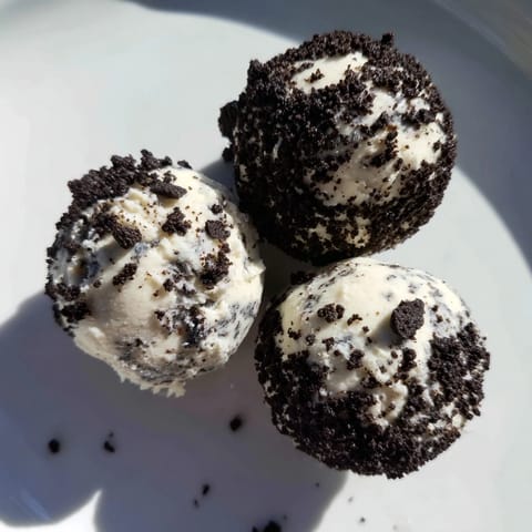 Enjoy a close-up of delicious Cream Cheese Oreo Protein Balls ready to grab and eat.