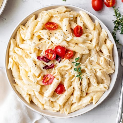 Creamy Baked Feta Pasta, with sweet roasted cranberries, basil garnish, served warm for dinner.