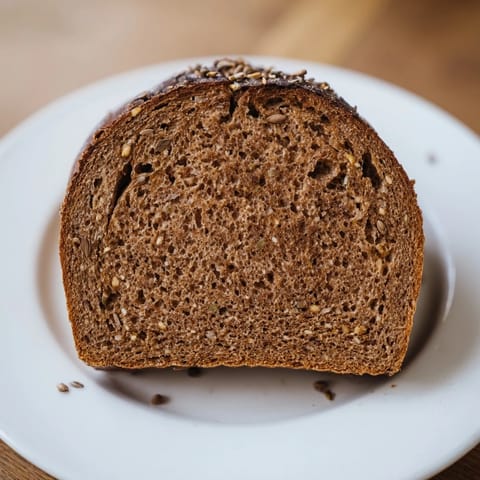 Perfectly baked Estonian Leib sourdough, showcasing a hearty crumb, ideal for sandwiches or snacks.