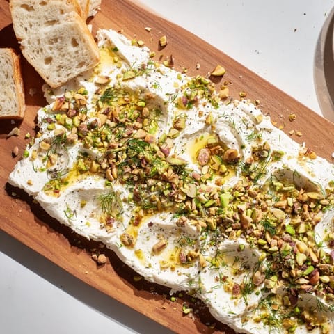 The butter is swirled beautifully and topped with crunchy pistachios, fresh chives, and a golden drizzle of honey.  