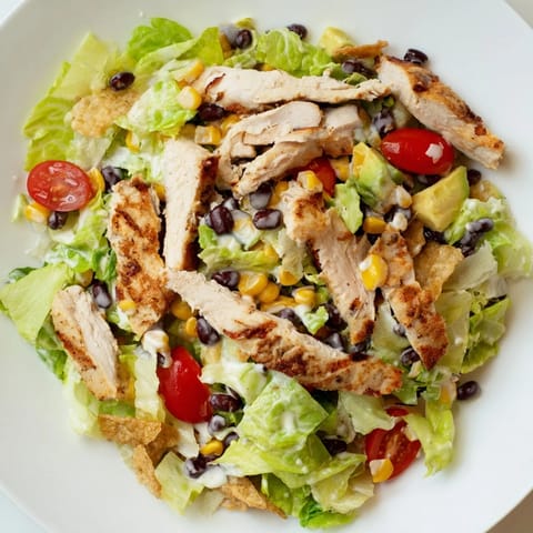 Hearty Crunchy Taco Chicken Salad with charred chicken, black beans, corn, cheddar, and fresh avocado.