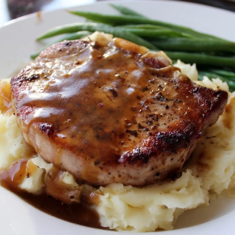 A close-up shot of the delicious pork chops & cheddar mash bowl, perfectly plated and ready to enjoy.