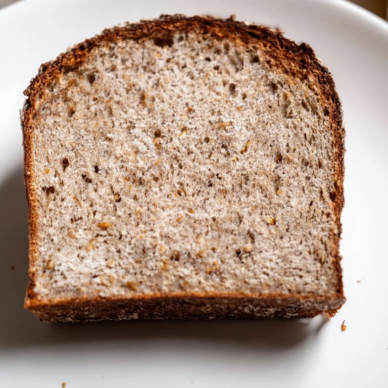 Imagine a rustic slice of Latvian Rupjmaize, its dark crust revealing a soft, flavorful interior.