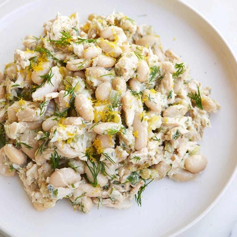 Serving suggestion for Lemony White Bean Chicken Salad: a chilled, protein-packed meal with creamy beans and tangy lemon dressing on a sunny plate.